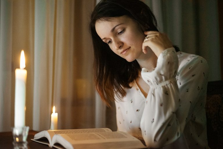 Person journaling in a cozy room, reflecting on self-worth